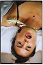 Woman in Black Tank Top Lying on Bed