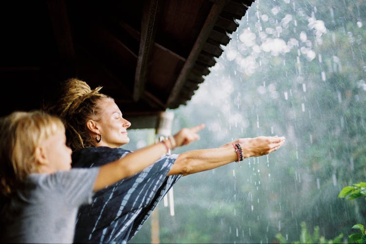 Woman And Child Washing Hands On Raindrops