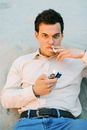 Man in White Dress Shirt Holding Black and Silver Box Mod