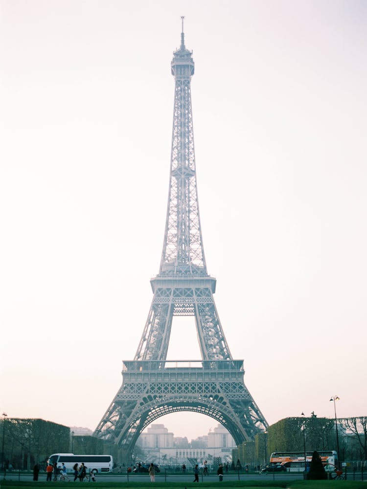 Busy People Walking Near The Eiffel Tower Under White Sky