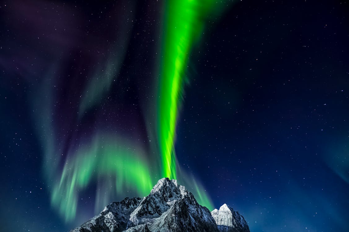Free A Snow Capped Mountain Under Sky with Northern Lights Stock Photo