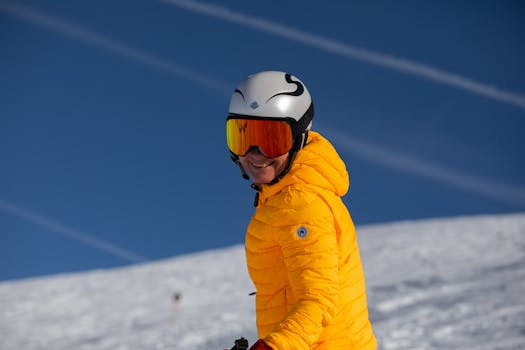 Ski enthusiast in a yellow jacket enjoying a sunny day on the Austrian slopes.