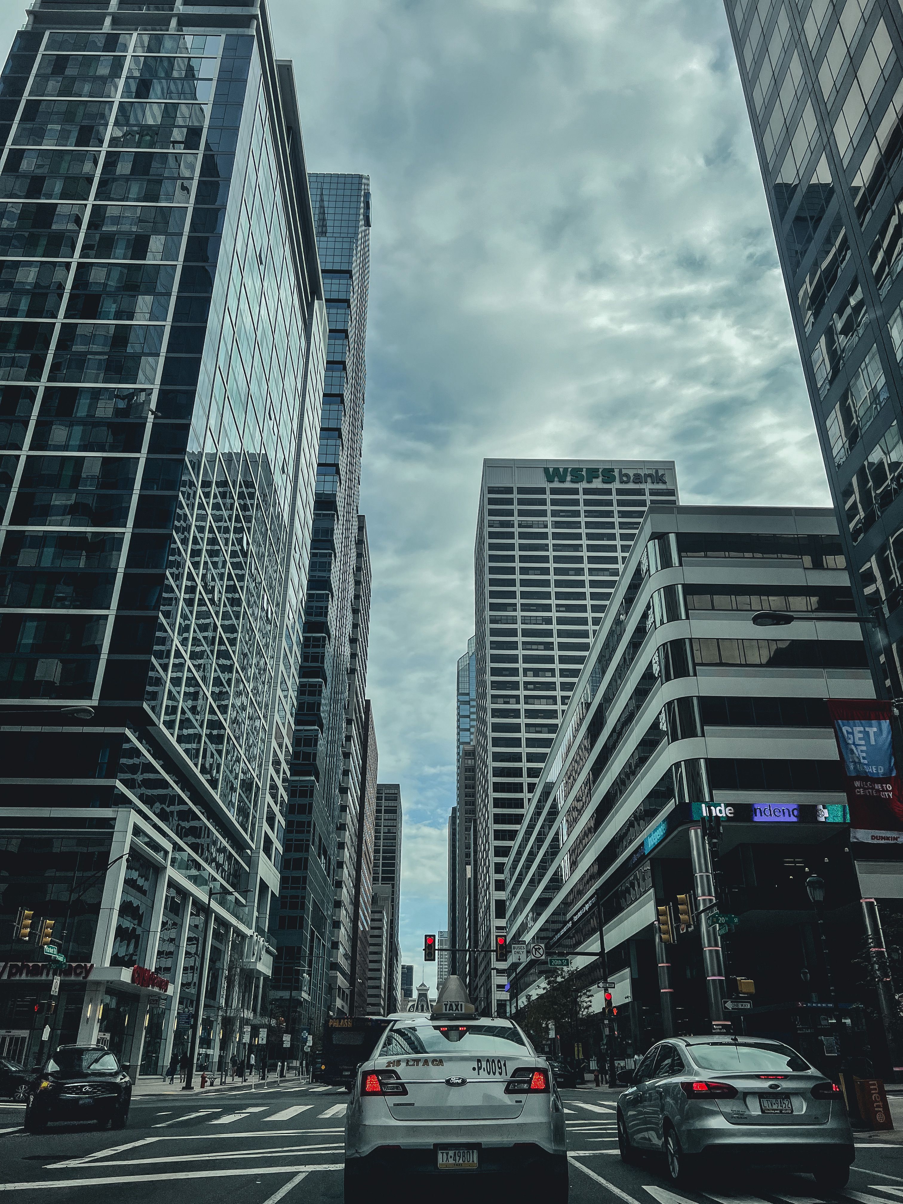Moving Cars on the Road Between High Rise Buildings · Free Stock Photo