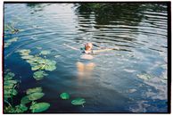 Girl in Pink Bikini Swimming on Water