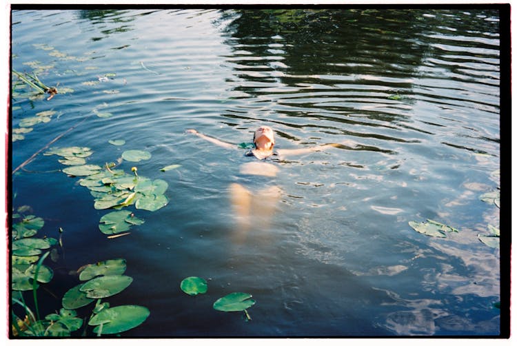 Woman In Black Bikini Swimming On The Lake