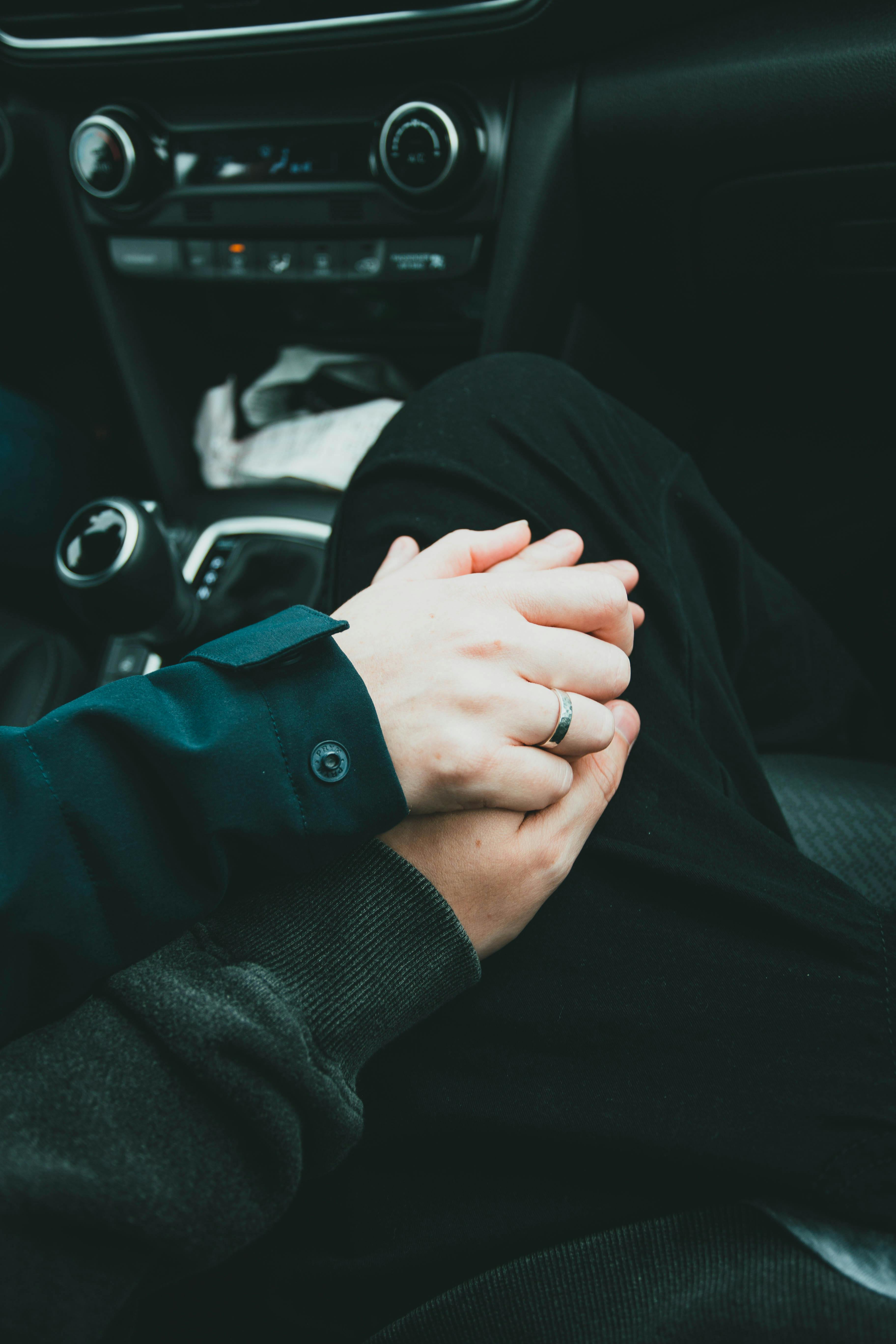 couple holding hands in the car