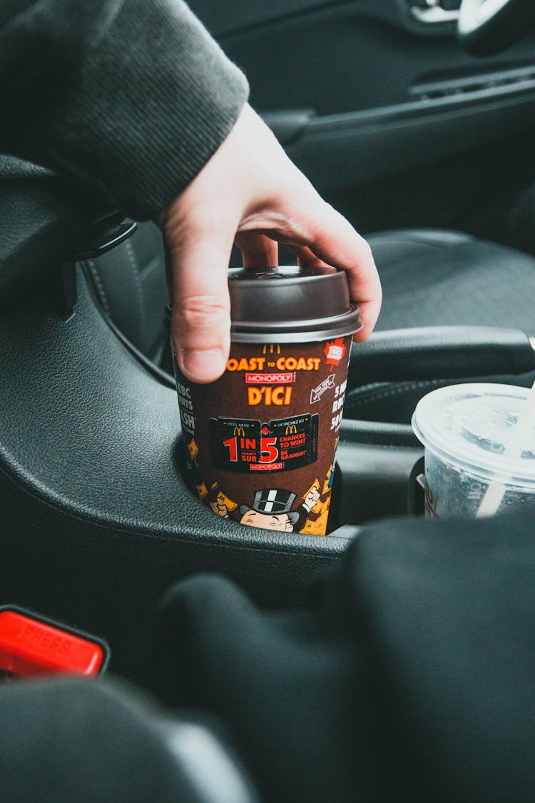 Close Up On Coffe Cup In Hand On Car