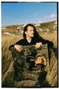 Woman in Black Long Sleeve Shirt Lying on Brown Grass Field