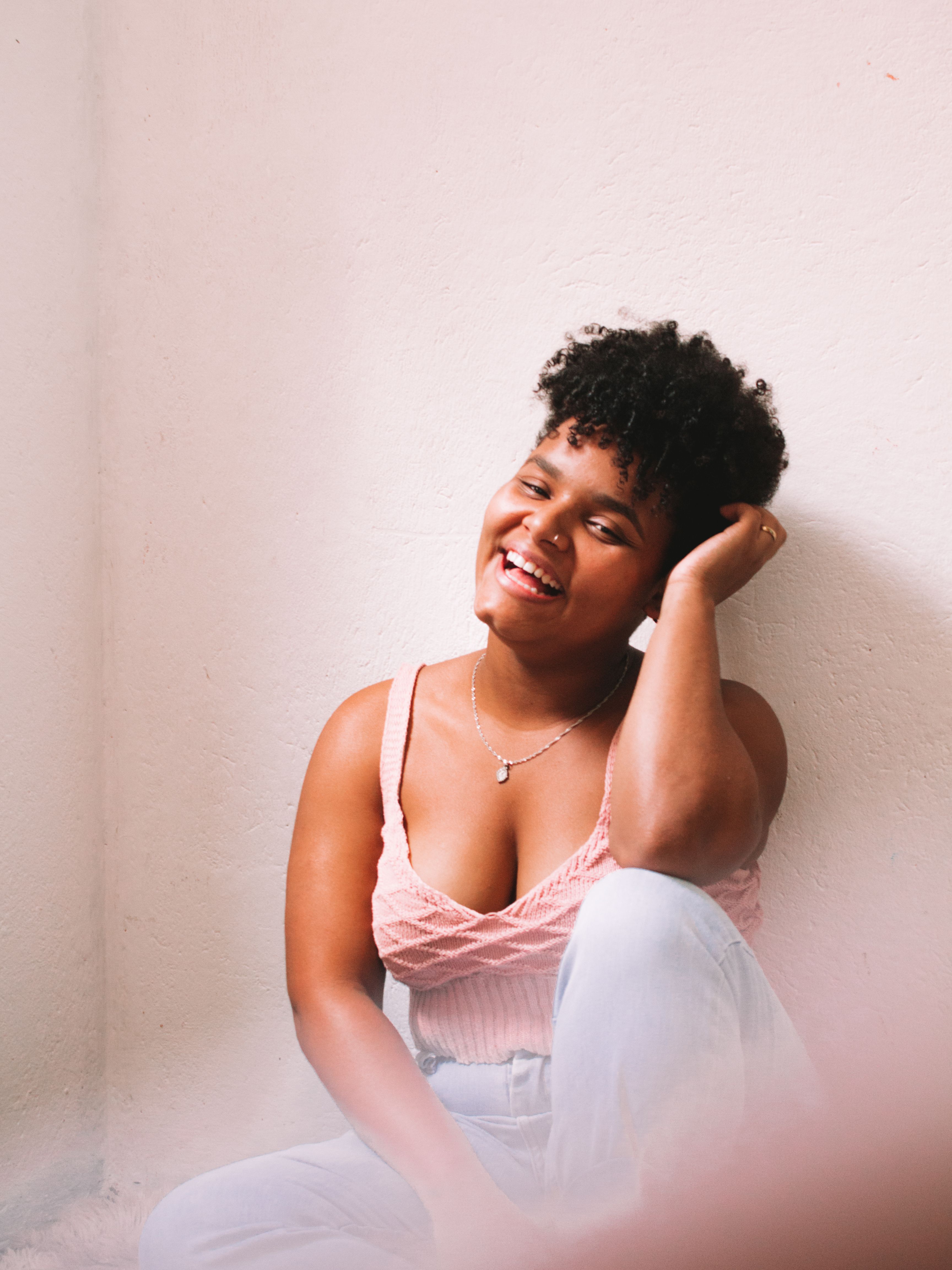Woman in a Pink Top Posing with Her Hand on Her Head · Free Stock Photo