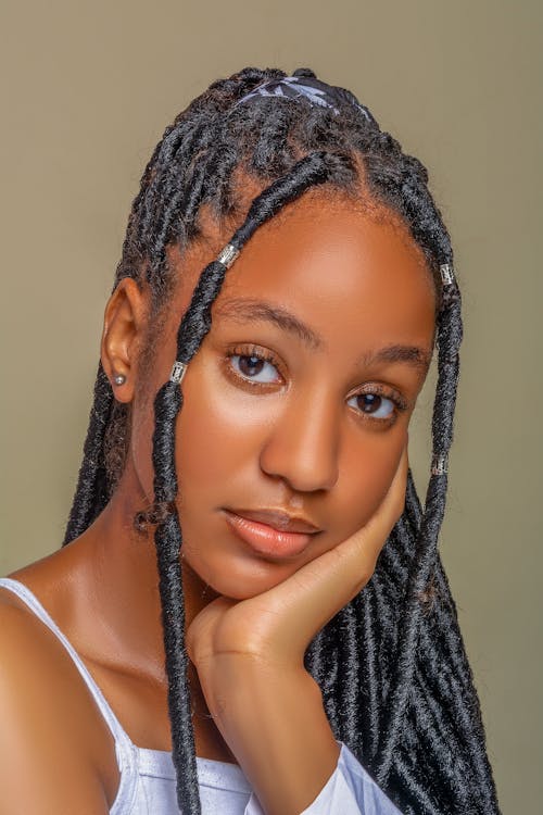 Beautiful Woman with Dreadlocks Posing with Her Hand on Her Chin