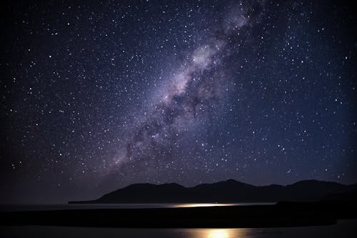 Silhouette of Mountain Under Starry Night