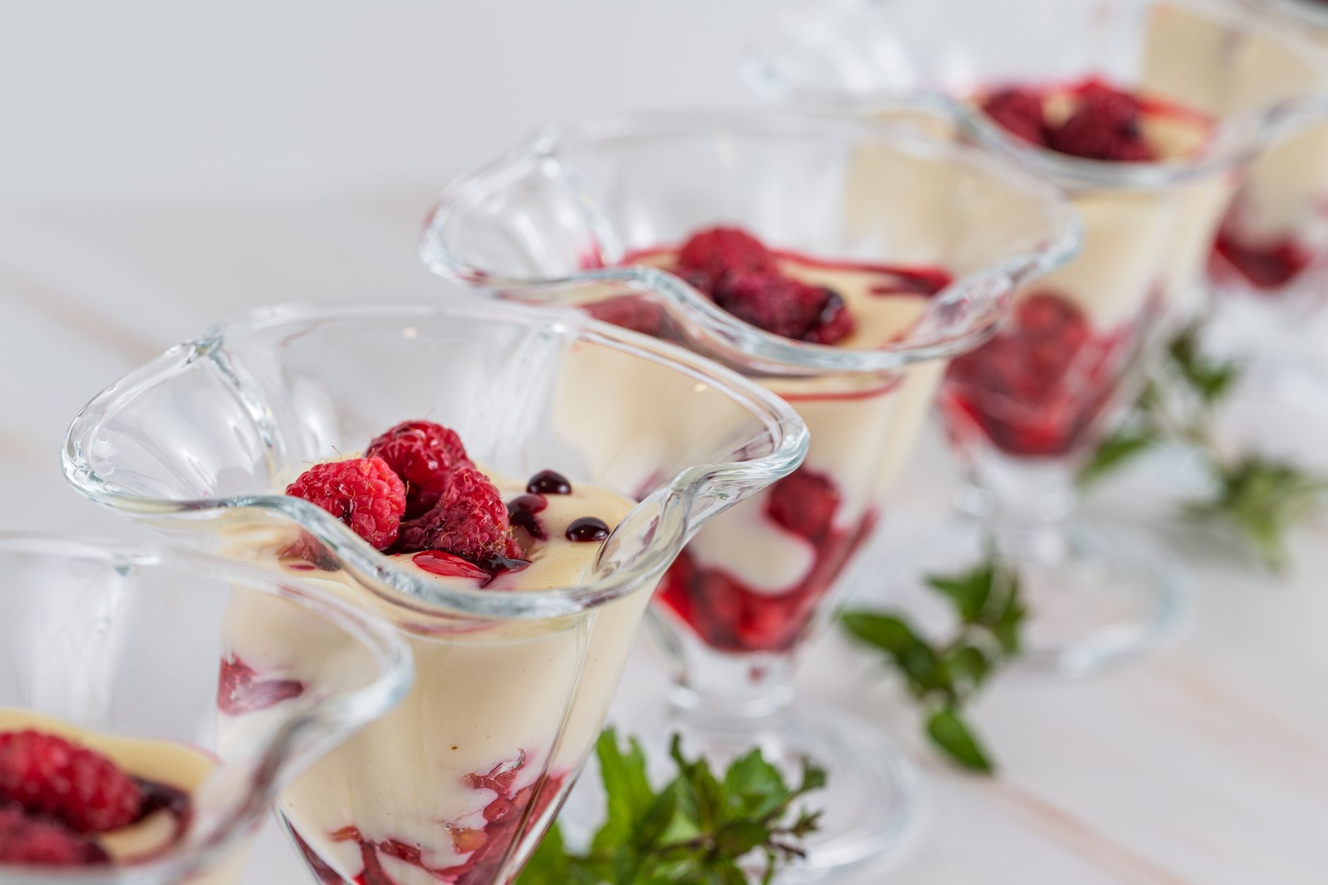 Close-up of caramelized creme brulee with berry sauce