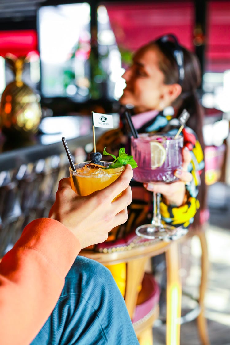 A Person Holding A Fruity Cocktail Drink