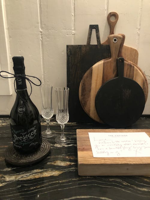 Cutting Boards next to a Wine Bottle 