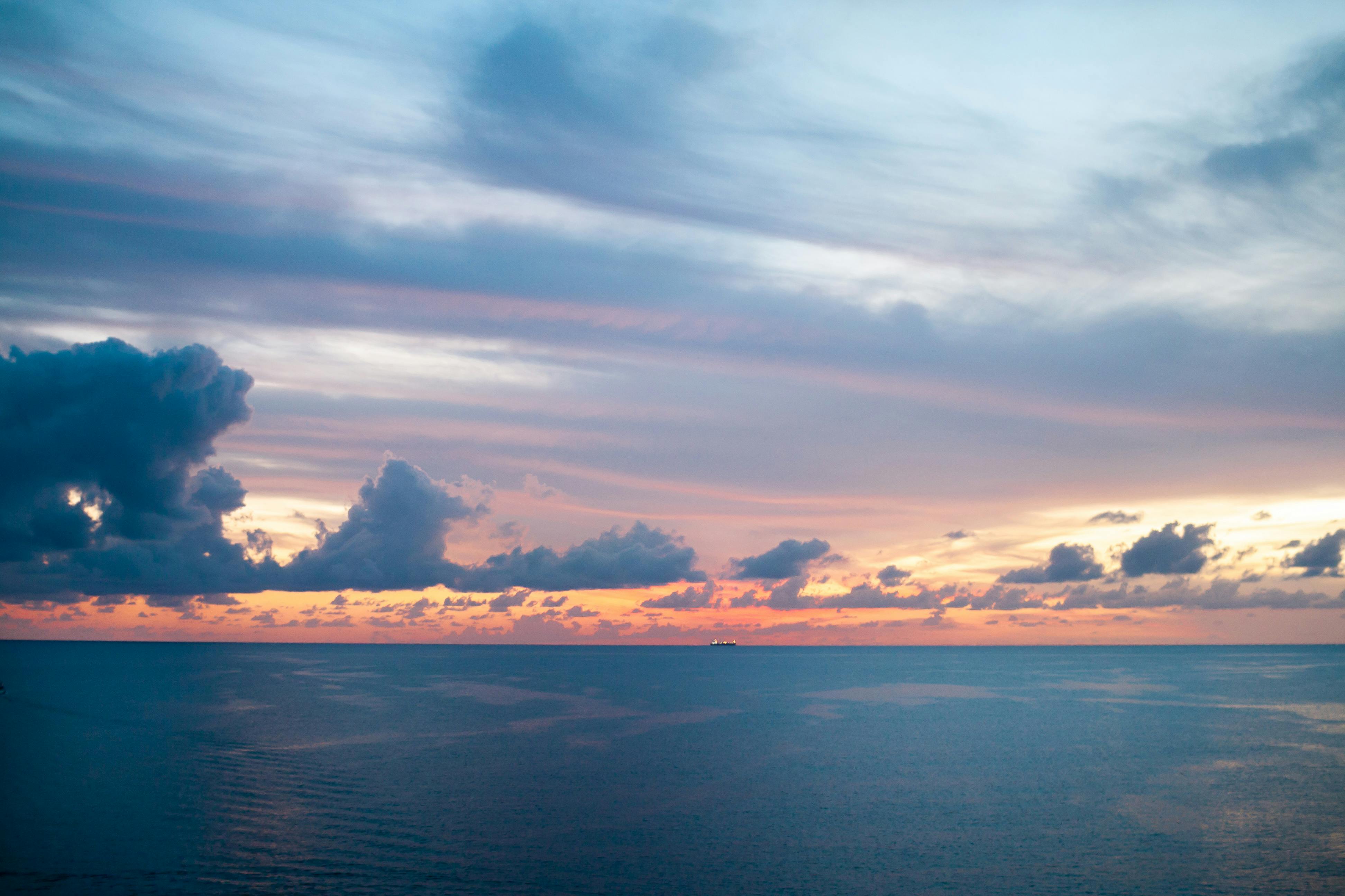 photo of sea and blue sky