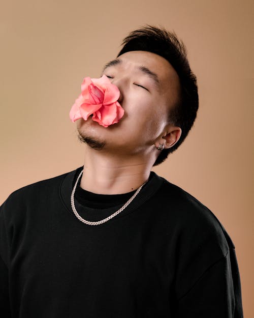 Free Man in Black Crew Neck Shirt With Pink Flower on His Mouth Stock Photo