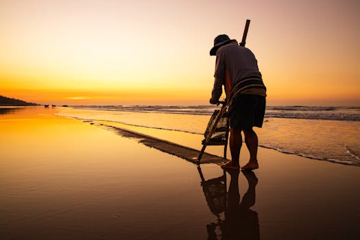 Traditional fisherman casting net at sunset on Hồ Tràm Beach, Vietnam.
