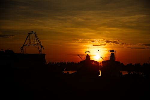 Silhouette of Ships on Dock during Sunset