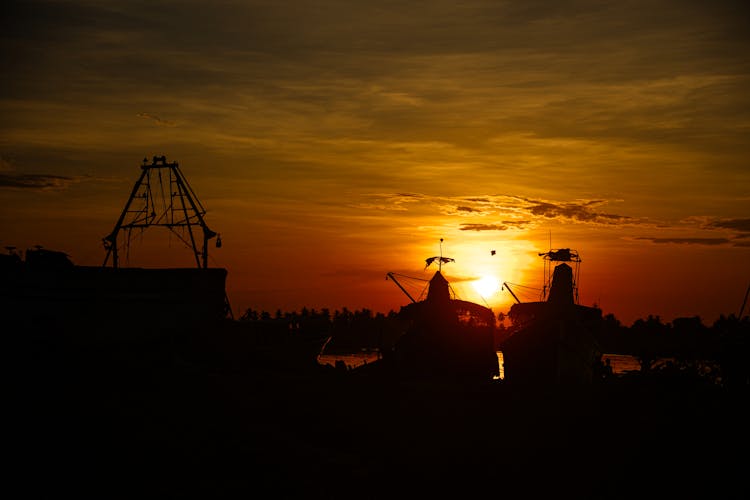 Silhouette Of Ships On Dock During Sunset