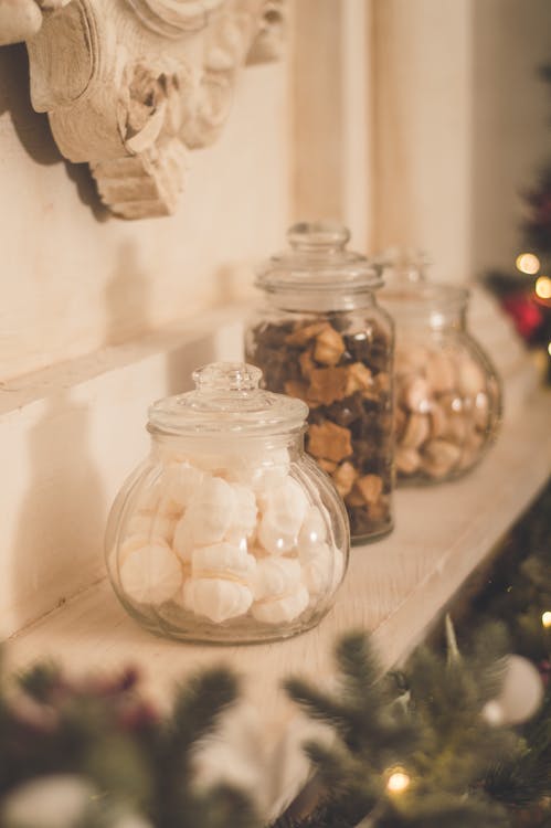 Clear Glass Jars on Wooden Shelf