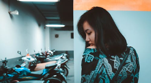 Photography of a Woman Near Motorcycles