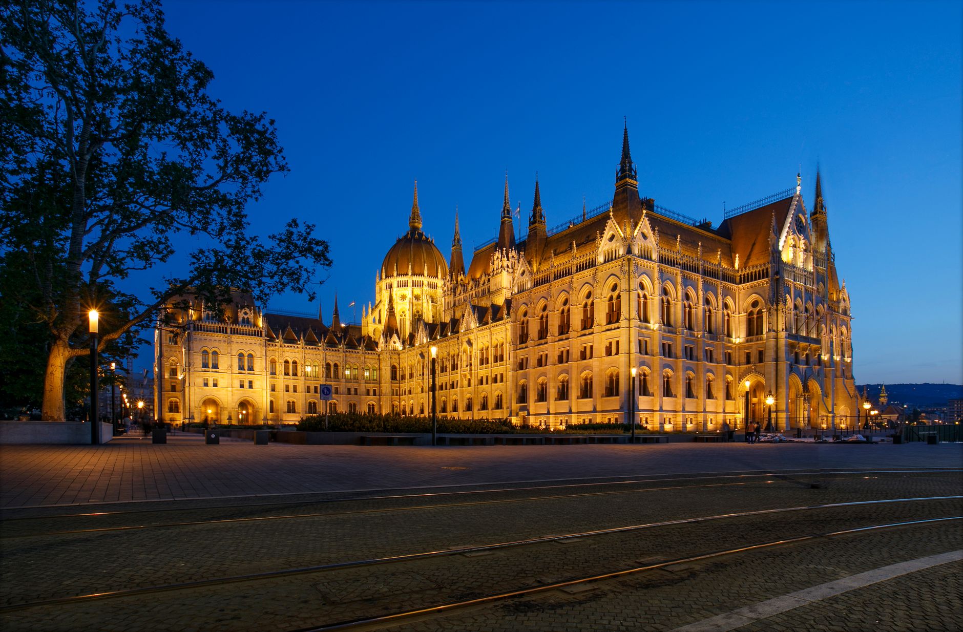 Illuminated Budapest Parliament Building at twilight highlighting its architectural beauty.