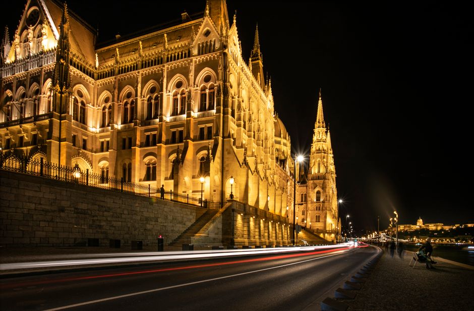 Hop-on Hop-off bus passing the Parliament building in Budapest, Hungary