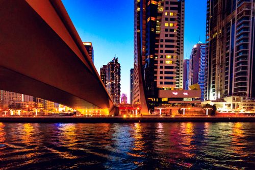 Free Explore the vibrant Dubai Marina skyline reflecting over water during twilight, capturing urban architecture at its best. Stock Photo