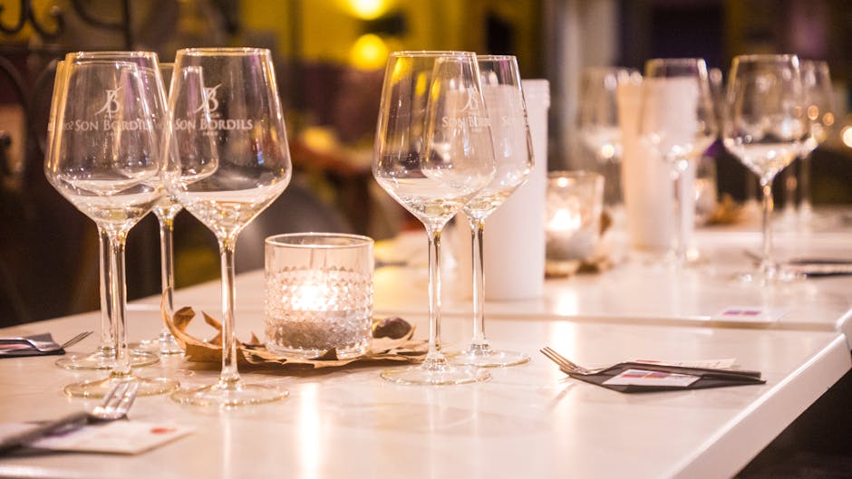 Elegant dinner table setting with glasses and candlelight in a cozy setting in Palma, Spain.