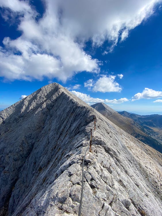 Gray Rocky Mountain Under Blue Sky and White Clouds