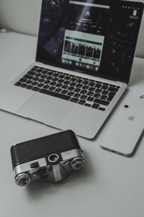 Analog Camera, Laptop and Phone on Desk