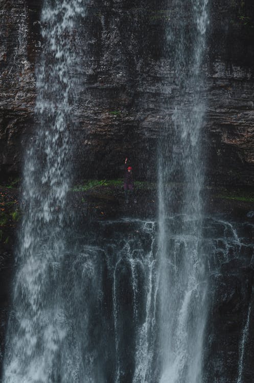 Person Standing behind Waterfall · Free Stock Photo