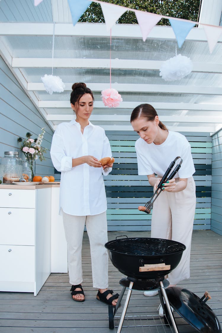 Women Grilling Food Using A Griller