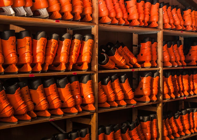 Orange Ice Skates On Wooden Shelves