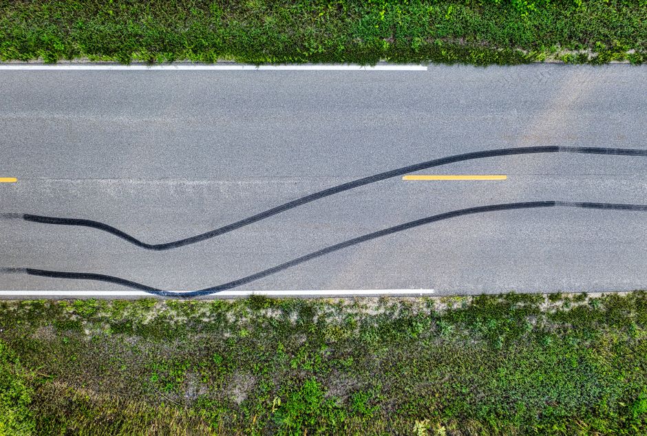 Drone shot of skid marks on a rural road in Welch, MN, highlighting texture and curves.
