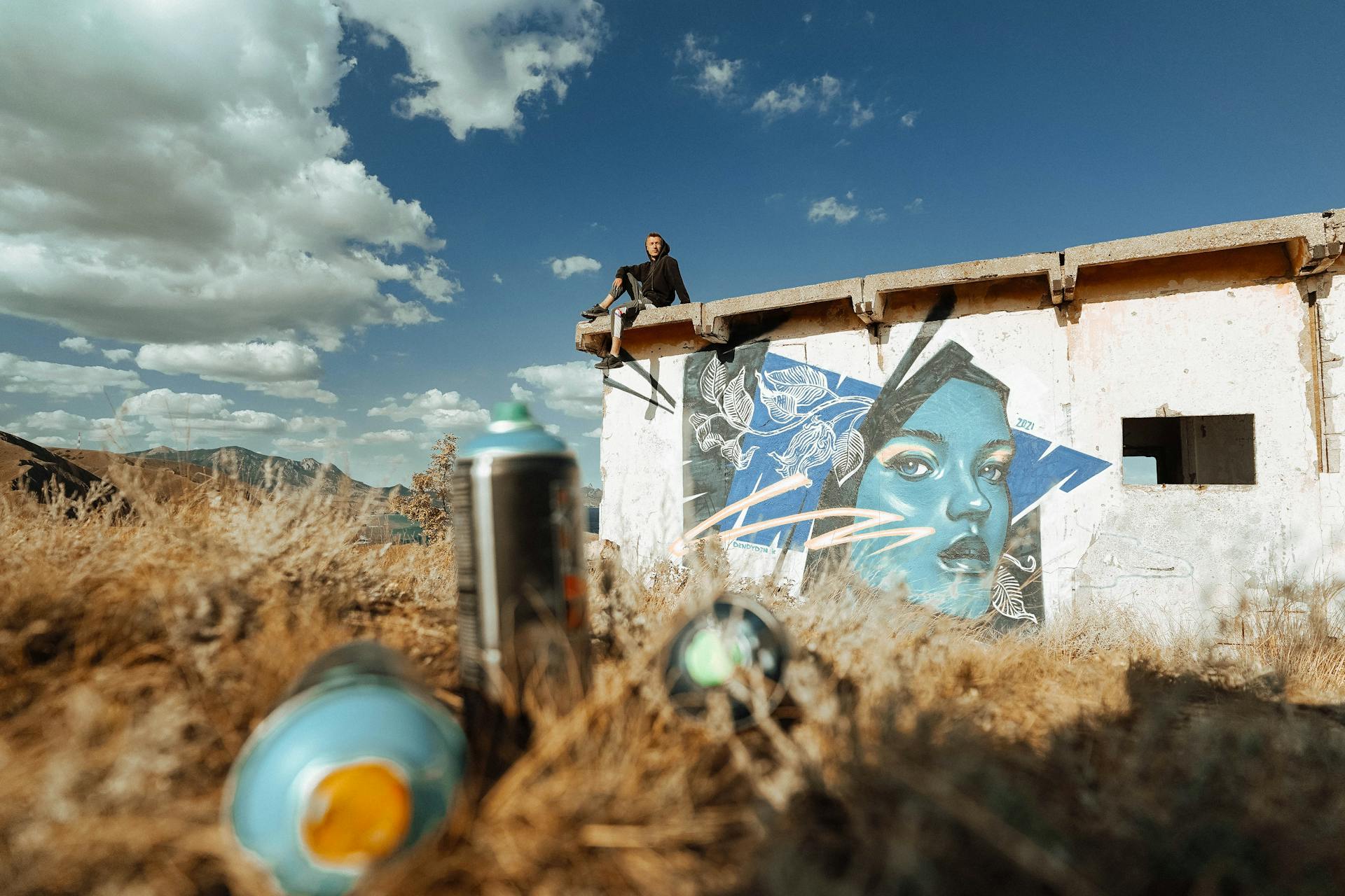 A Man Sitting on the Roof of an Abandoned Building