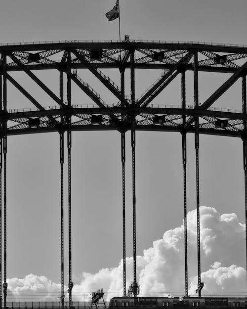 Free Grayscale Photo of a Flag on Top of Sydney Harbour bridge Stock Photo