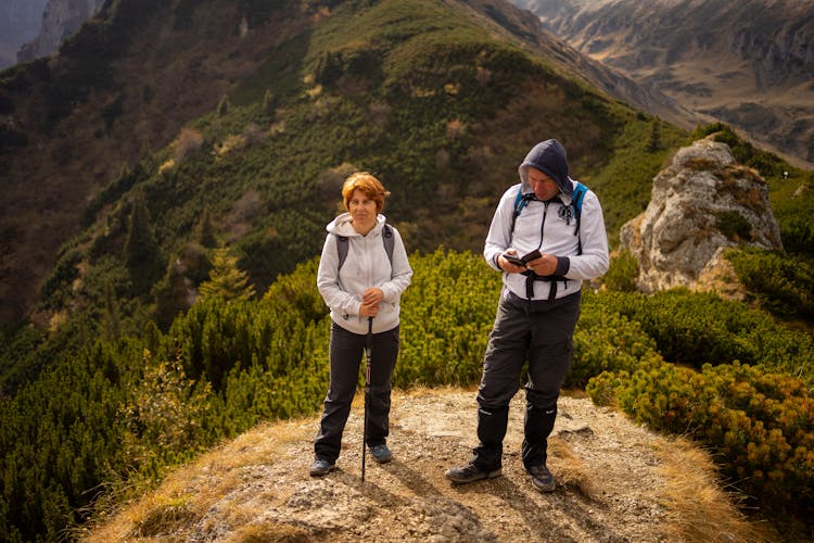 Middle-Aged Couple Hiking In Mountains 