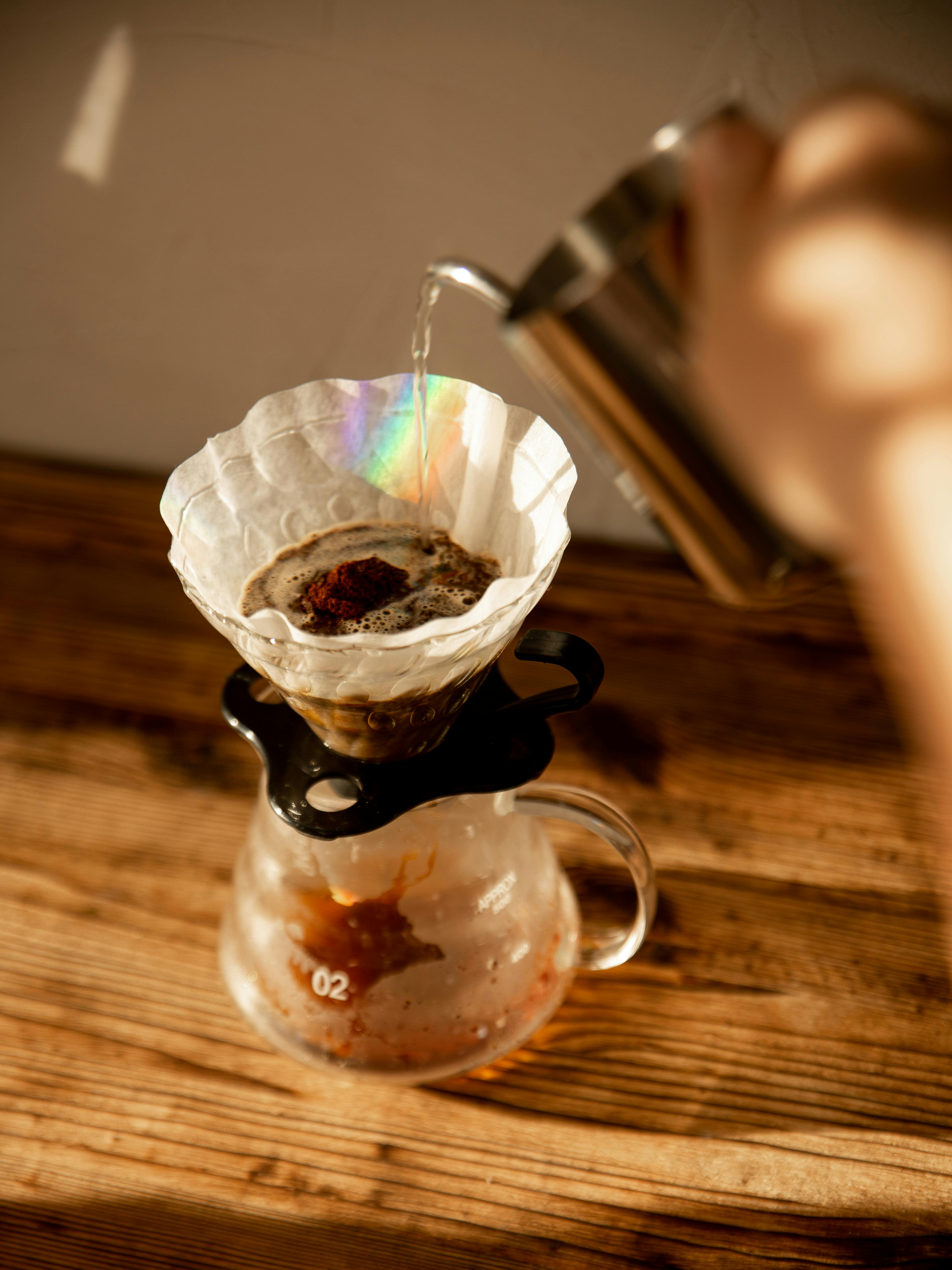 Person Pouring Liquid in a Clear Glass · Free Stock Photo