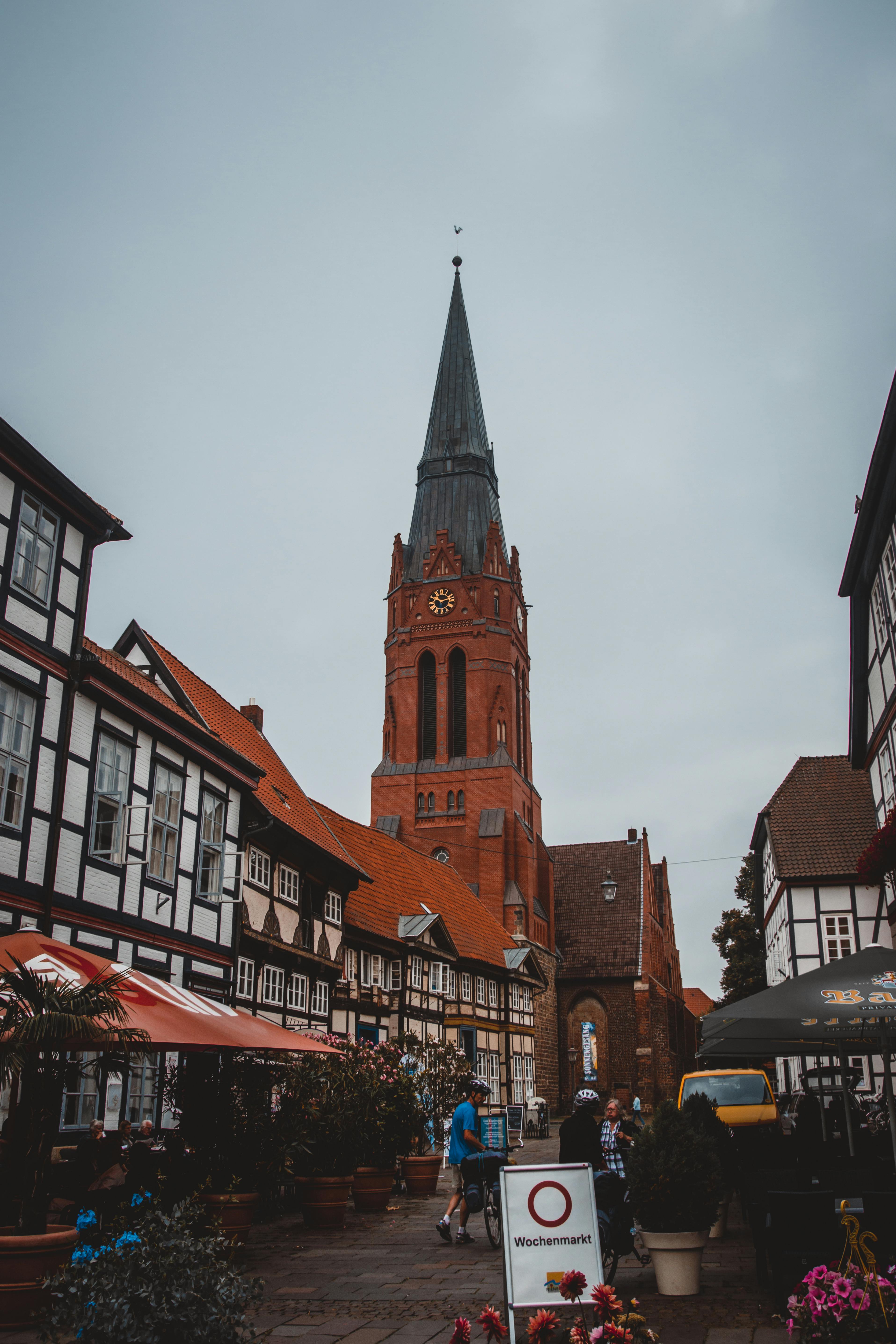 黄昏时分，风景如画的城镇广场上矗立着历史悠久的钟楼和半木结构建筑