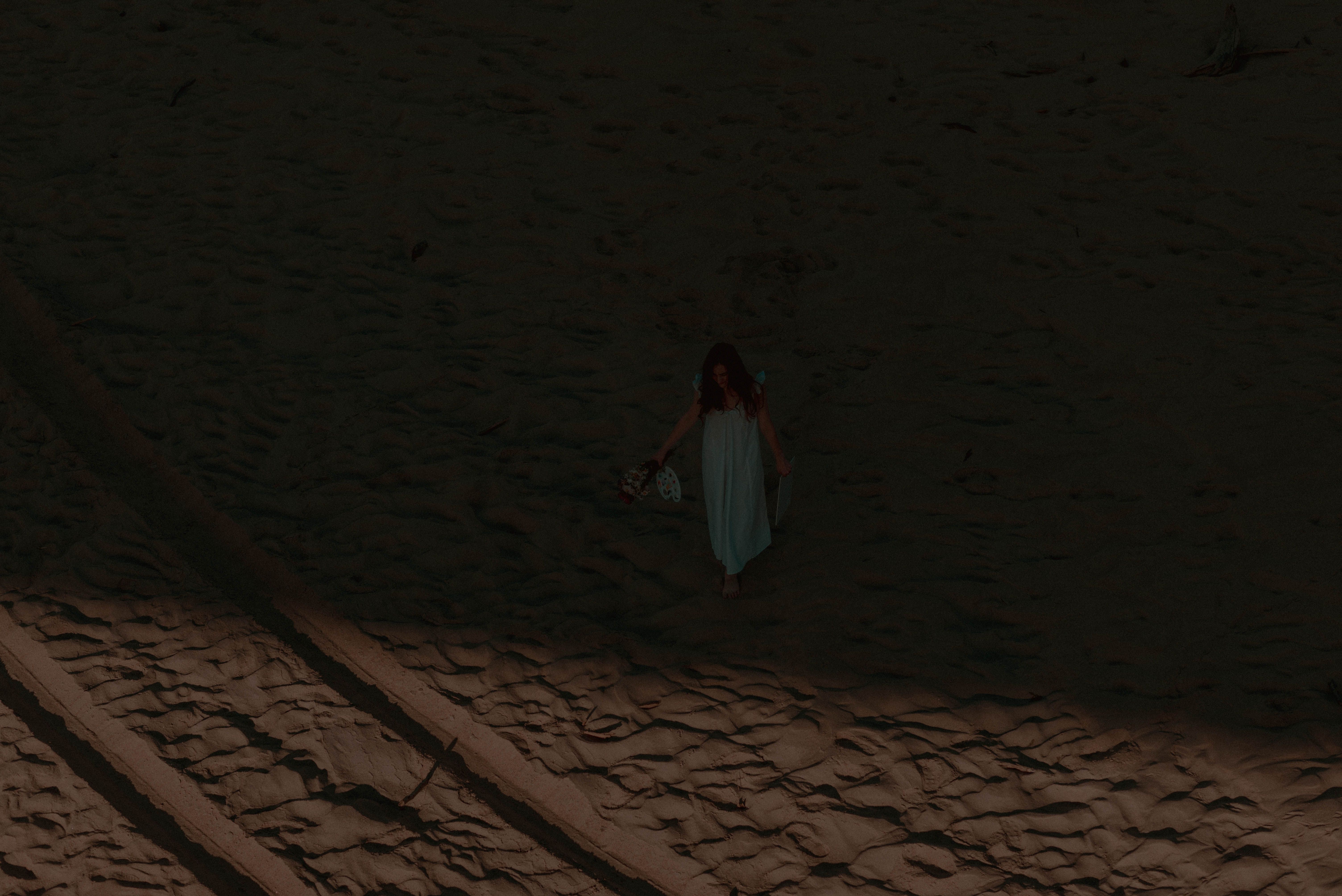Woman in White Dress Walking on Sand · Free Stock Photo