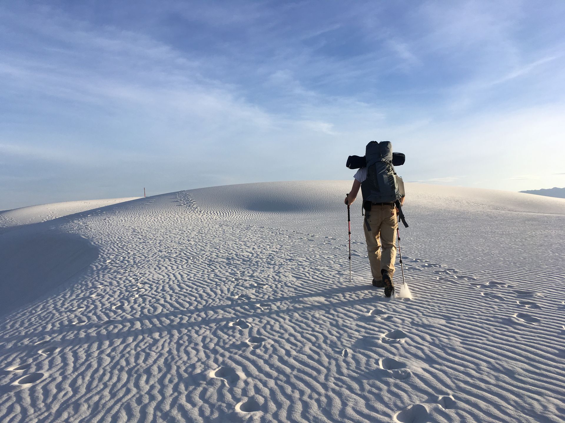 Photo of Man Holding Hiking Poles on Snow Field