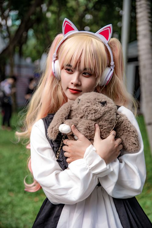 Free Young woman in cosplay attire holding a stuffed toy outdoors. Stock Photo