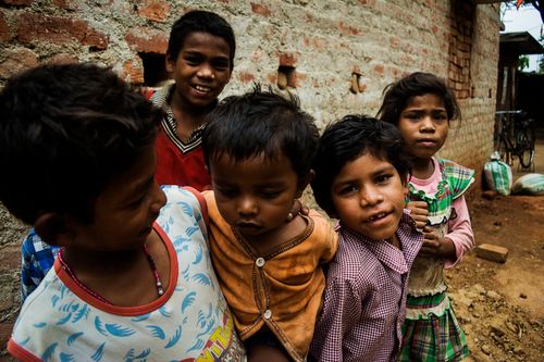 Free A lively group of South Asian children enjoying their time outdoors in an Indian village. Stock Photo