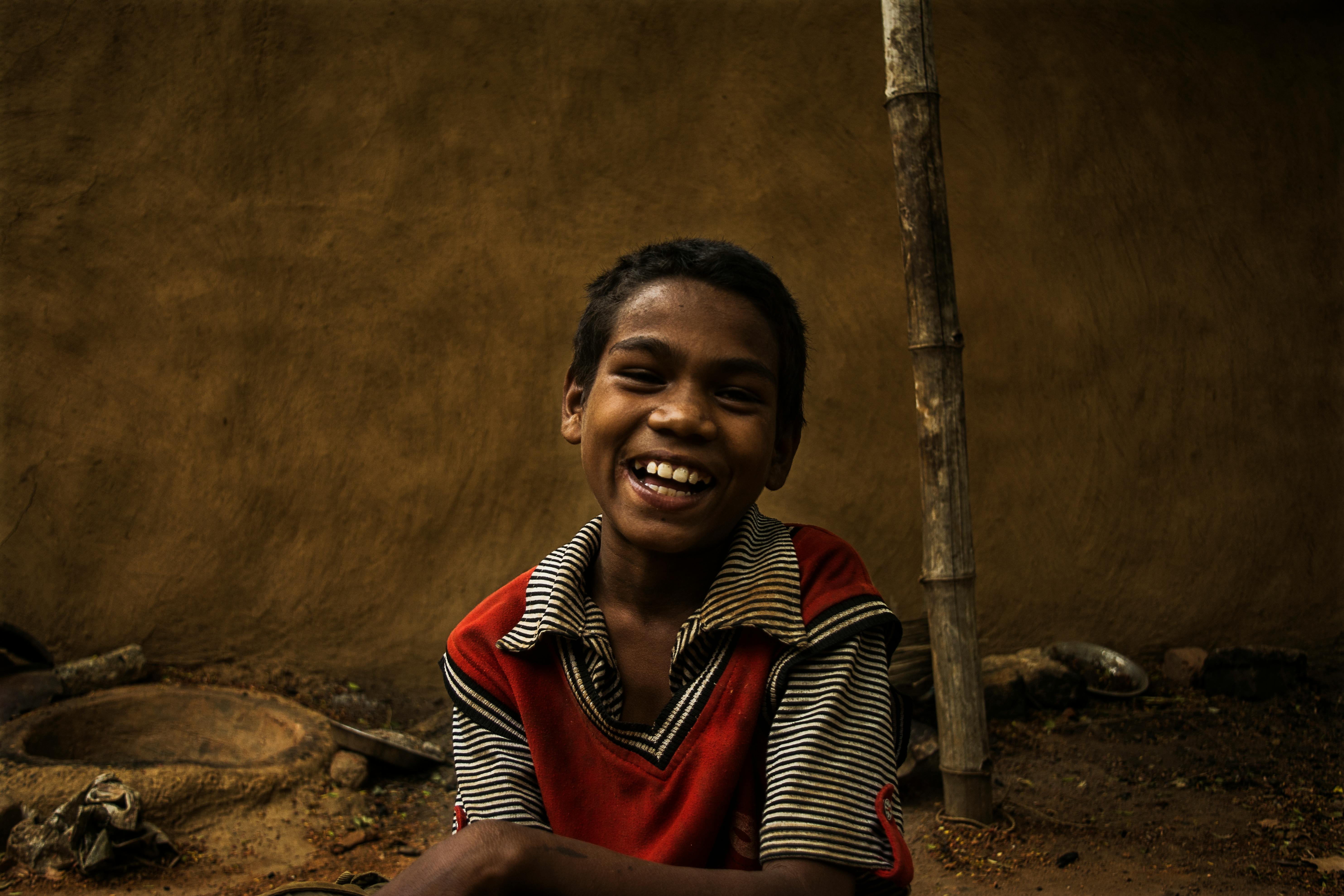 A joyful child smiling outdoors in Ranchi, India, showcasing happiness and innocence.