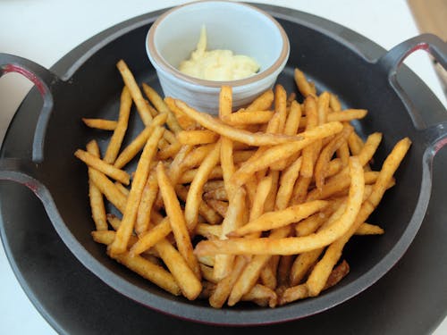 Close-Up Photo of Fried French Fries Beside a White Dip