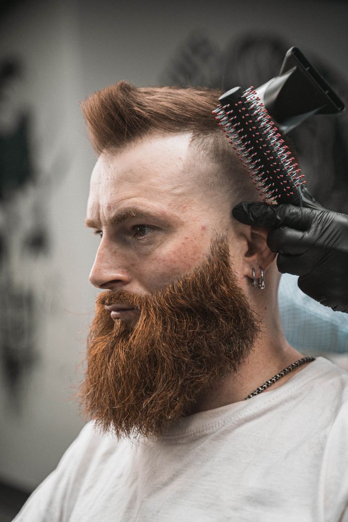 Buzz cut paired with a shaped beard