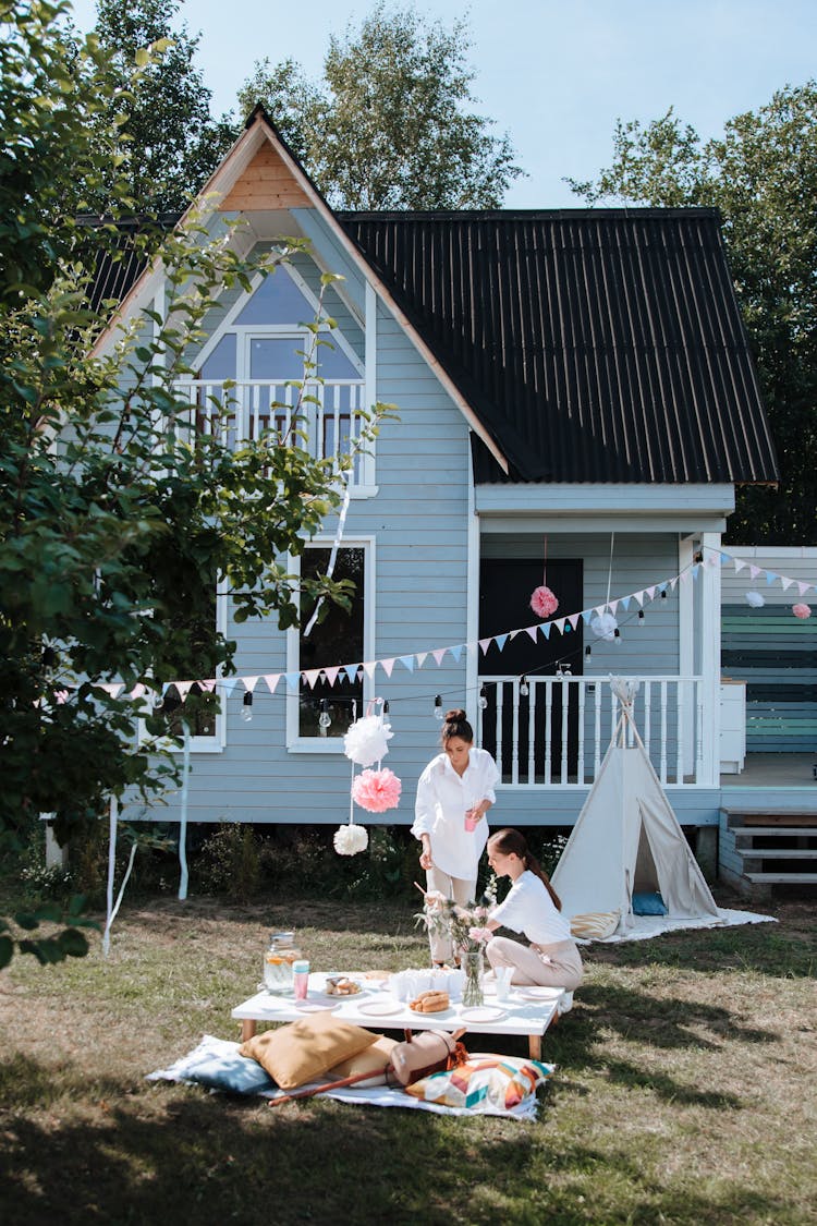 Two Women Doing Picnic Outside The House