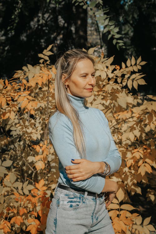 Photo of a Woman with Blond Hair Wearing a Blue Turtleneck Shirt