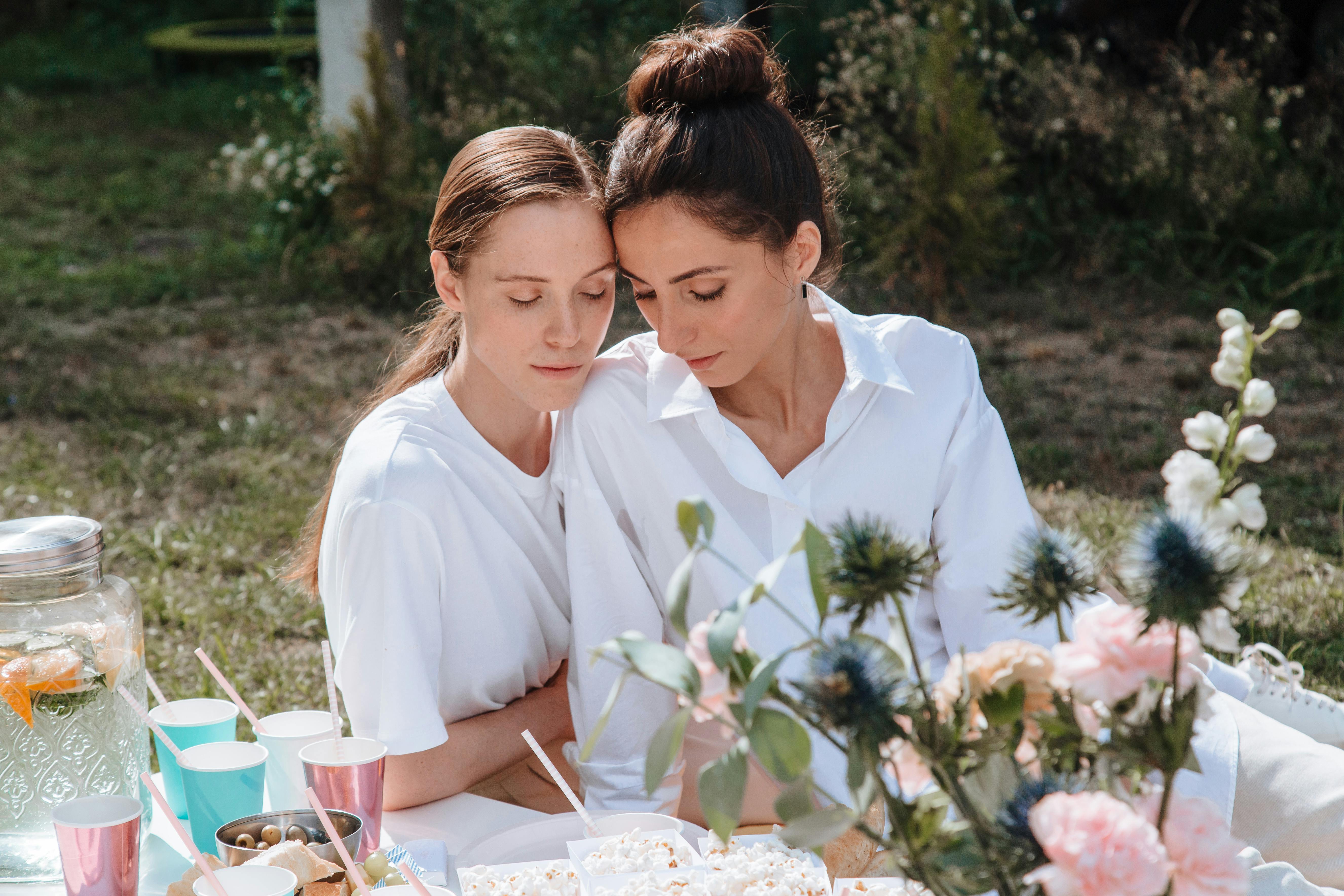 women in white shirts with their eyes closed